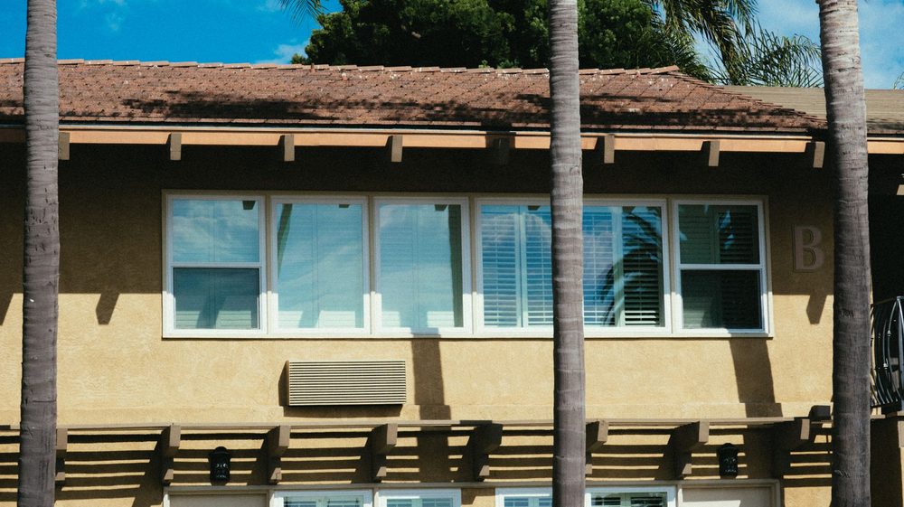Modern home facade with palm trees
