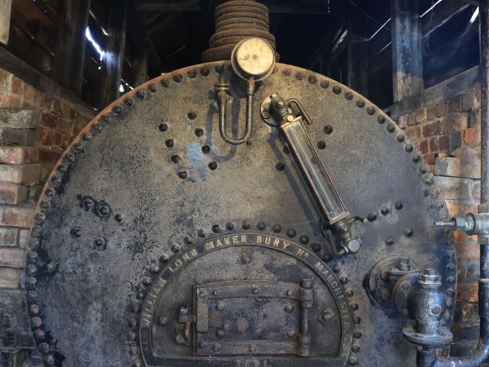 Industrial steam boiler with metal fittings.